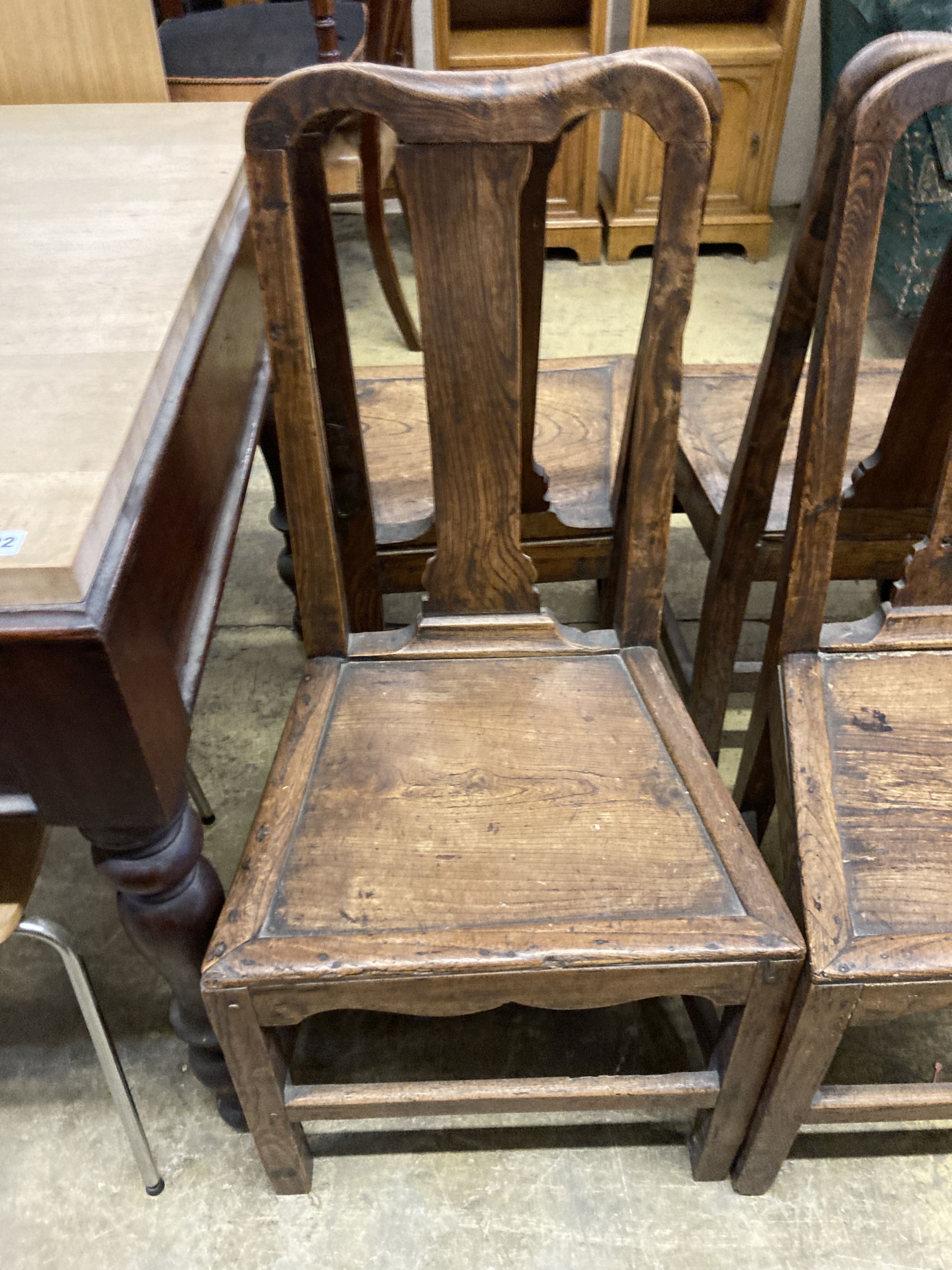 A set of four 18th century provincial elm wood seat dining chairs